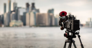 video camera in front of a city scape.