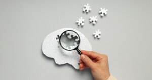 individual holding a magnifying glass