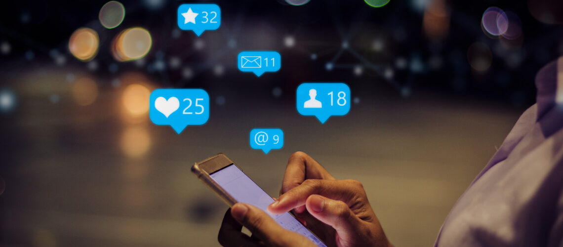 Person holding a smart phone liking posts on the internet.