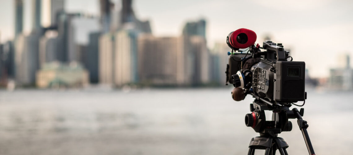 video camera in front of a city scape.