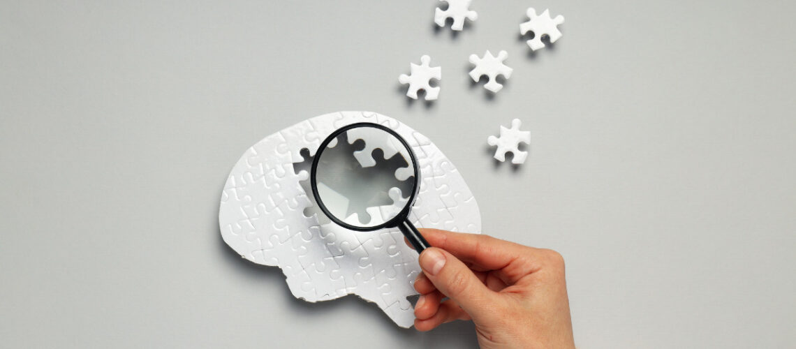 individual holding a magnifying glass