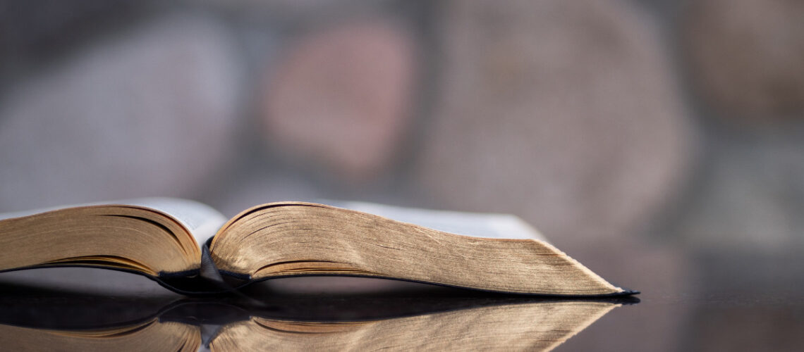 a book with gold pages laying open on a table
