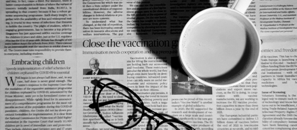 glasses and a mug on a newspaper