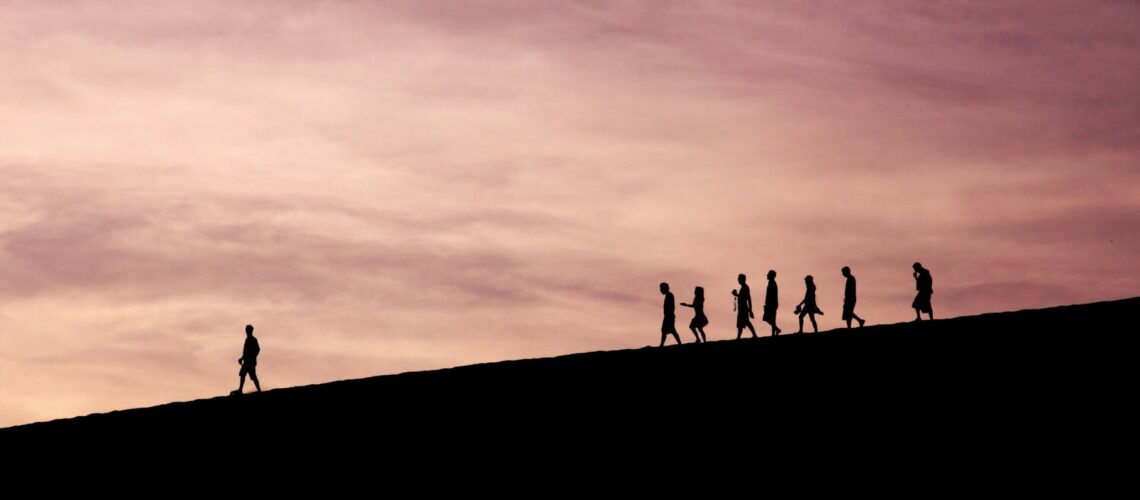 silhouette of people on hill